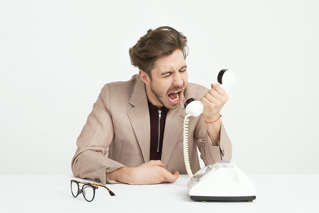 How to Use Emotional Intelligence for Excellent Relationship Management at Workplace 2 Emotionally unintelligent man screaming on the phone