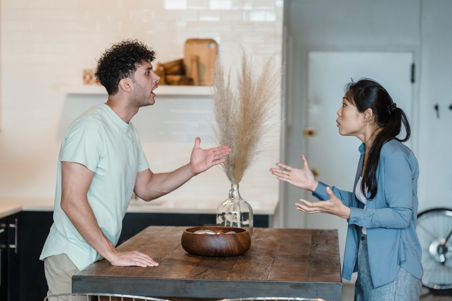 a couple standing at a table arguing in an imperfect relationship to achieve a true relationship