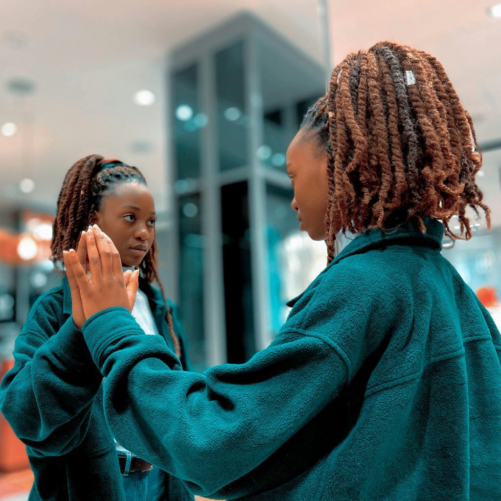 The Ultimate Self-Awareness Guide: Emotional Intelligence at Workplace 2 a woman looking at herself for greater self awareness